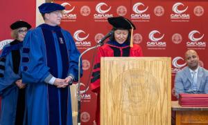 Dr. Keiko Kimora of Cayuga Community College assists in the conferral of degrees.